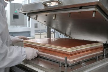 High frequency PCB laminate cores and bonding layers aligned in an industrial vacuum press