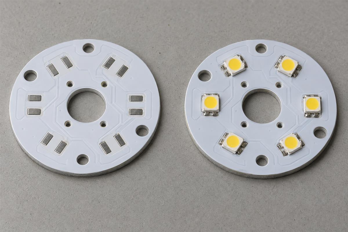 Bare white LED circuit board beside a populated LED module, AI illustration