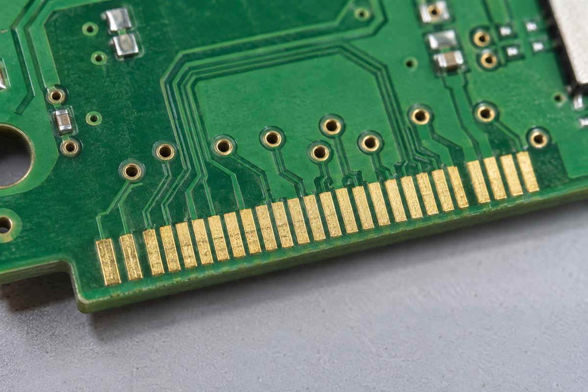 Illustrative PCB edge contacts and plated via holes