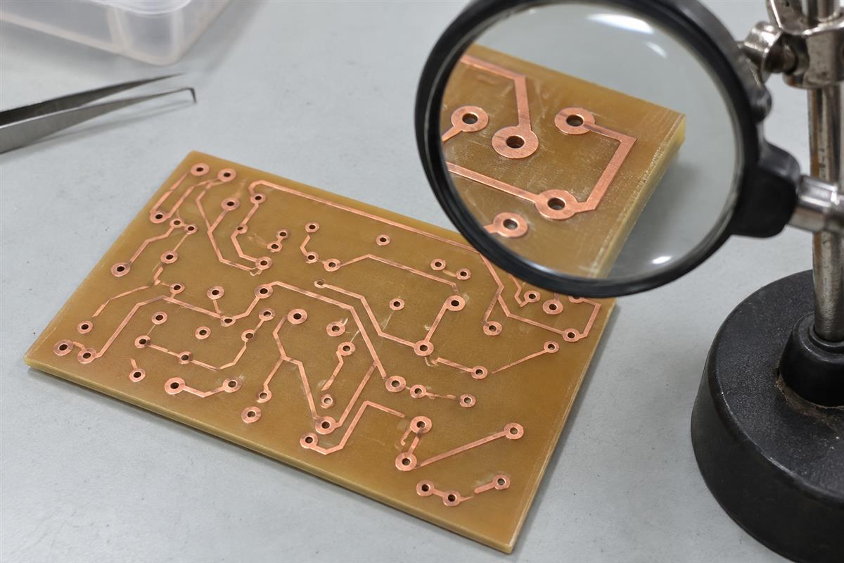 Unpopulated circuit board viewed with an inspection magnifier, AI illustration