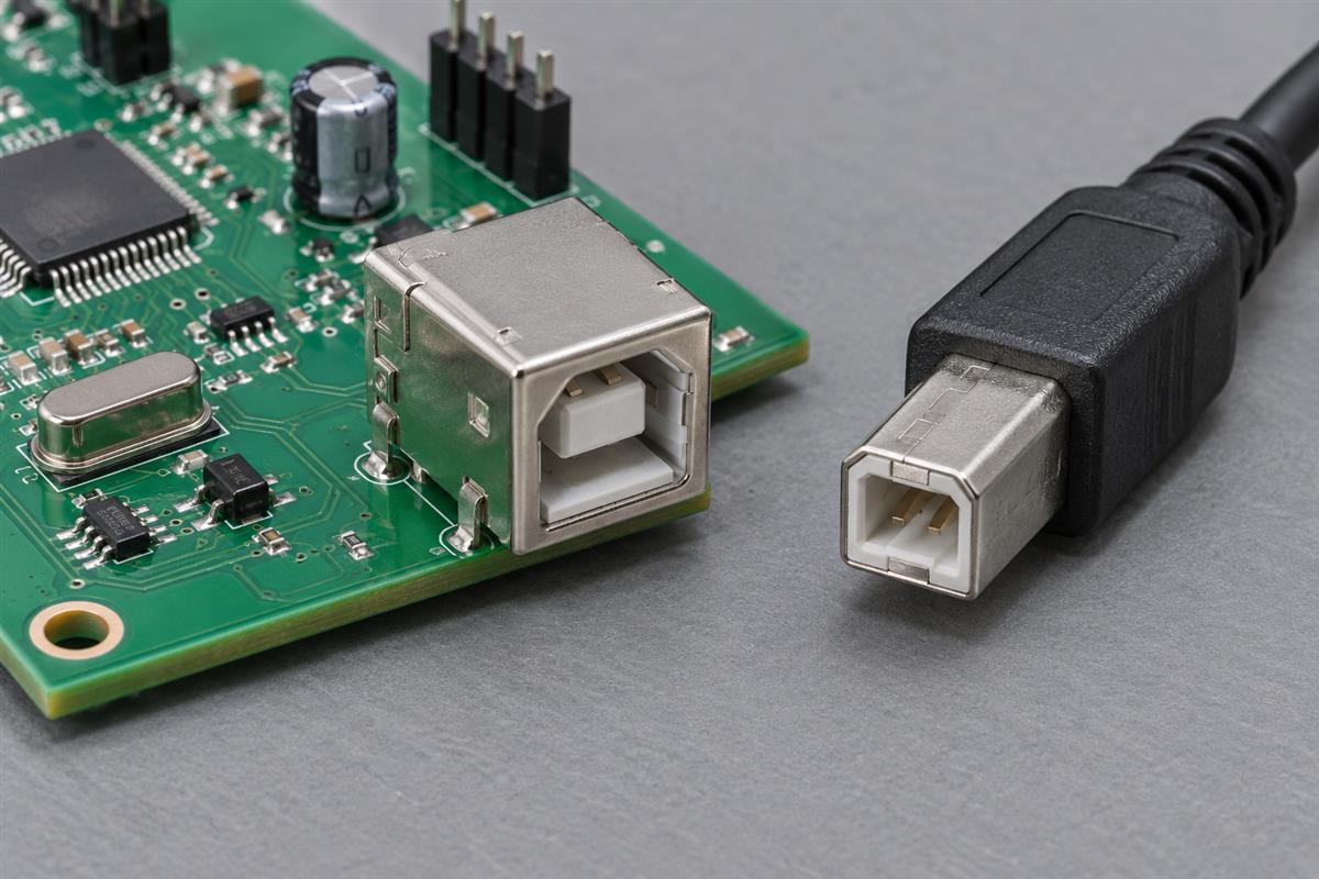Close-up of a circuit board connector beside its matching cable plug