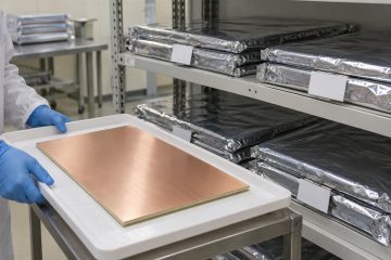 Sealed packages of PCB laminate and prepreg supported on a clean storage shelf