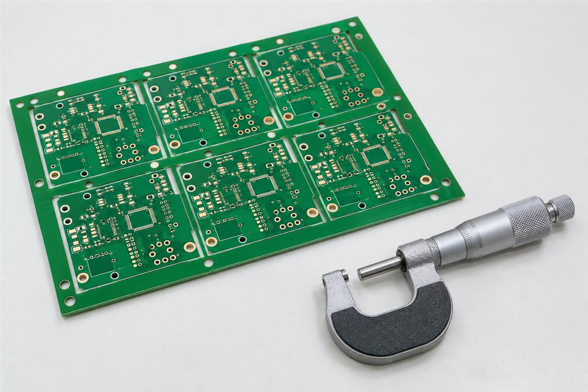 Illustrative bare PCB panel and dimensional measuring instrument on an inspection bench
