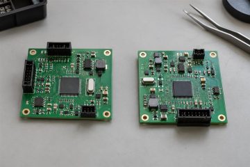 Two physical circuit board prototypes arranged side by side for revision comparison