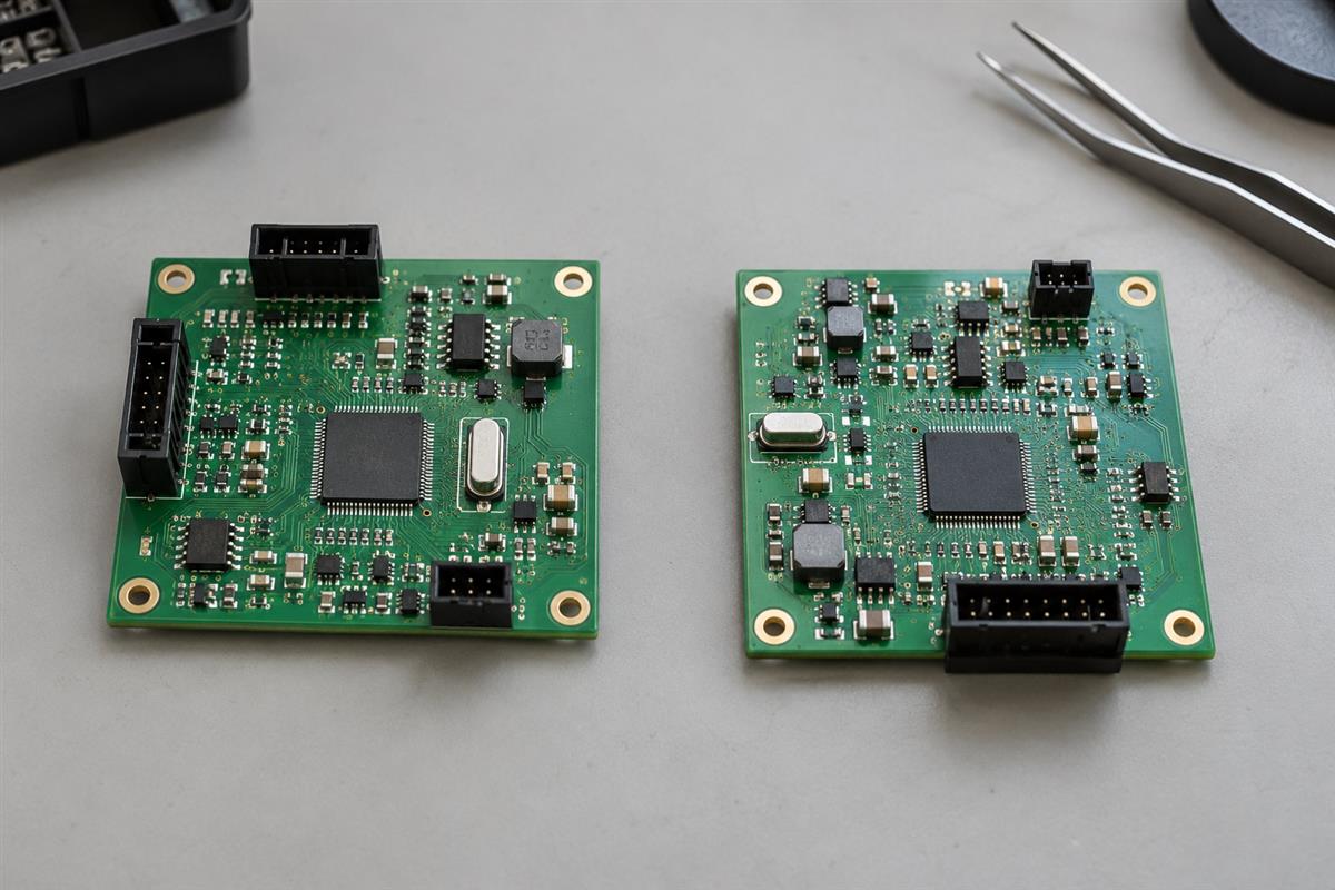Two physical circuit board prototypes arranged side by side for revision comparison