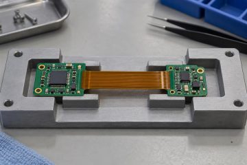 Illustrative rigid-flex circuit with two rigid islands supported flat in an assembly fixture