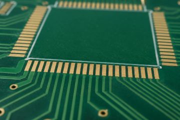 Illustrative green PCB with narrow solder mask strips between exposed fine-pitch pads
